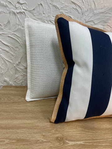 Comfortable outdoor cushion in navy and white stripes with jute edging